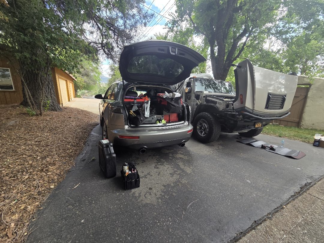 VIPCANIC mobile mechanic working on a car in a customer's driveway